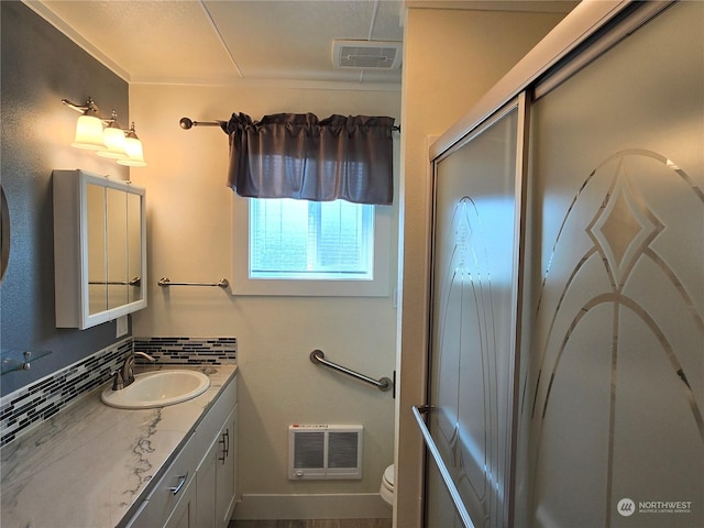 bathroom with toilet, visible vents, backsplash, and vanity