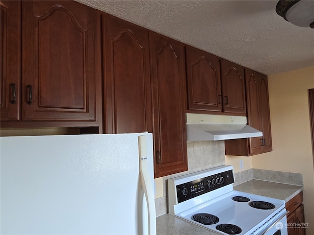 kitchen with white appliances and a textured ceiling