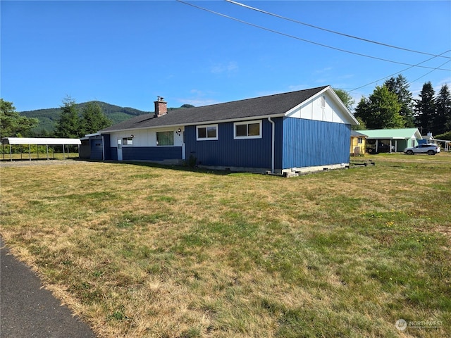 exterior space with crawl space, a chimney, and a yard