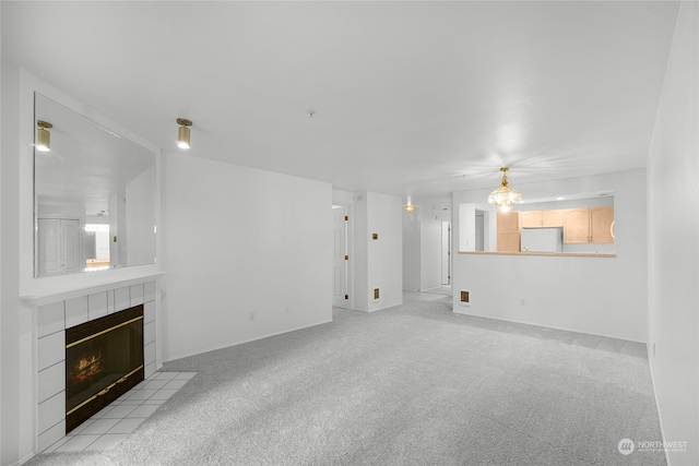 unfurnished living room with light carpet and a tile fireplace