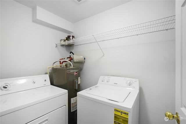 clothes washing area with washing machine and clothes dryer and water heater