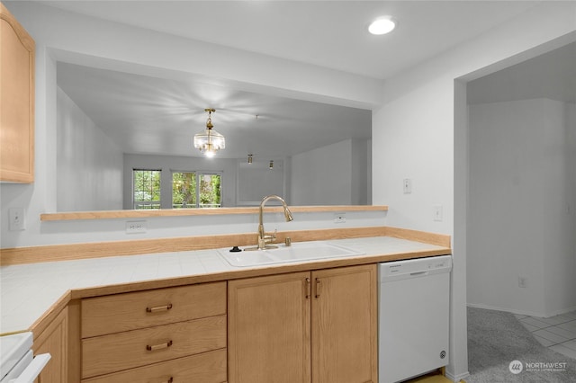 kitchen featuring a sink, light brown cabinetry, range, and dishwasher