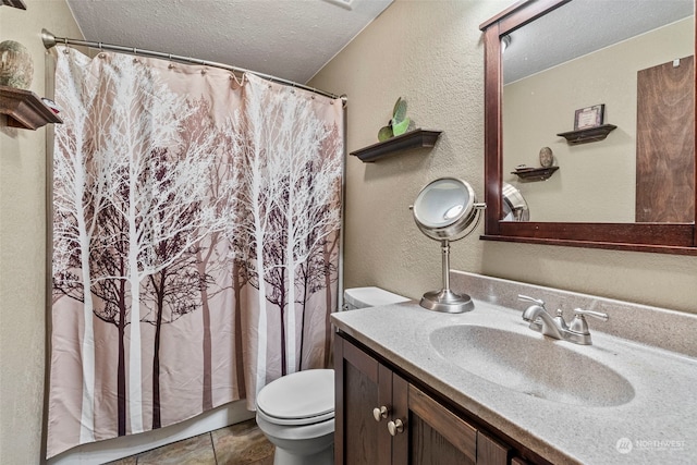 full bath featuring a textured ceiling, a textured wall, toilet, a shower with shower curtain, and vanity