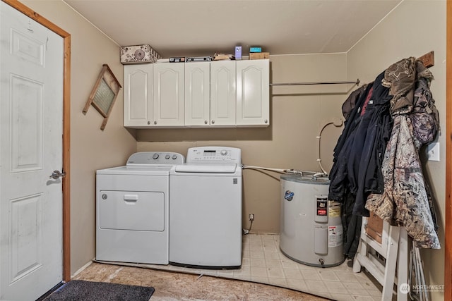 washroom with cabinet space, washer and clothes dryer, and electric water heater