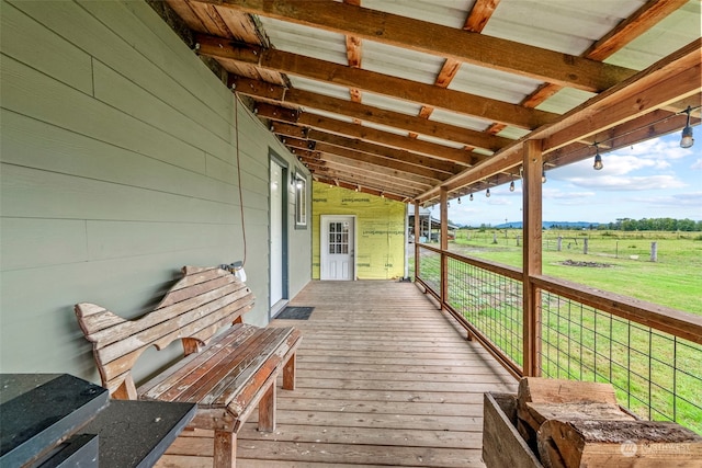 wooden deck with a rural view