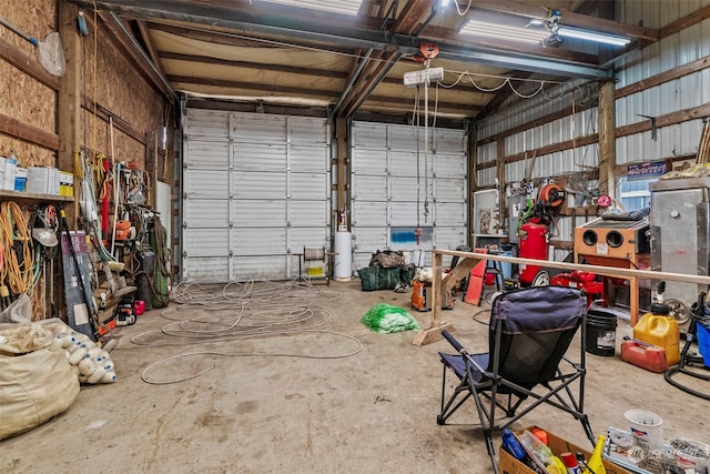 garage with a garage door opener and metal wall