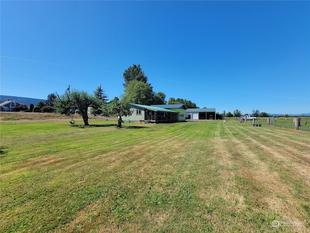 view of yard featuring a carport and a rural view