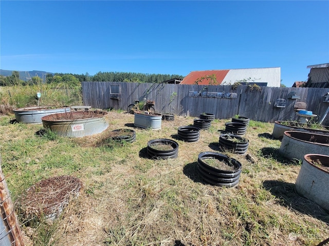 view of yard with a garden and fence