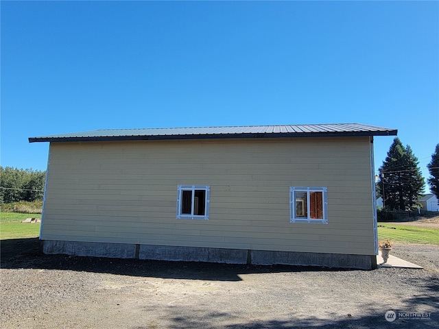 view of property exterior featuring metal roof