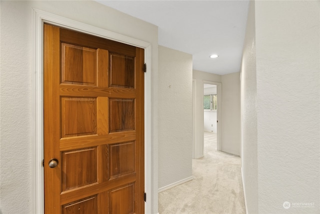 hallway with light colored carpet