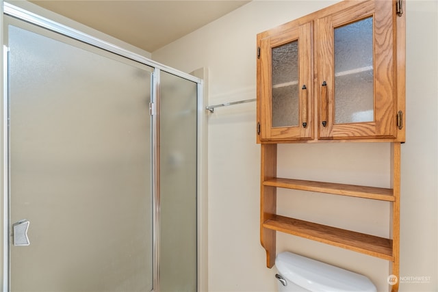 bathroom featuring toilet and walk in shower