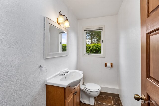 bathroom with tile patterned floors, toilet, and vanity