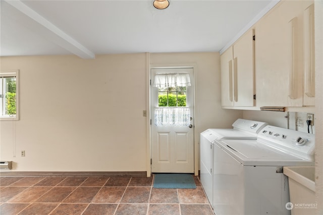 washroom featuring a baseboard radiator, cabinets, washing machine and dryer, and sink