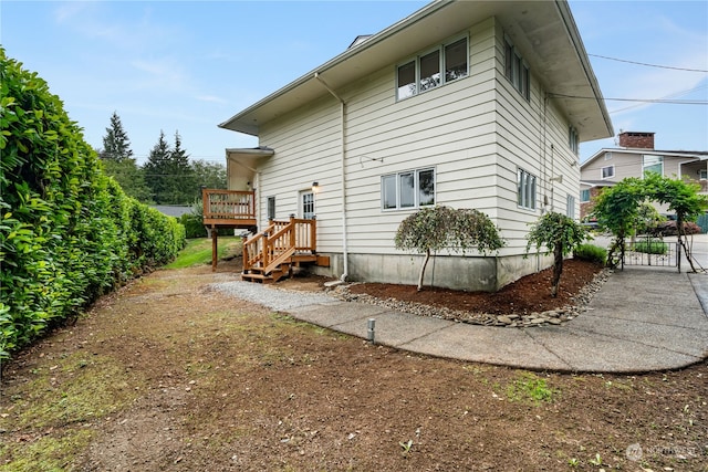 view of side of home with a deck