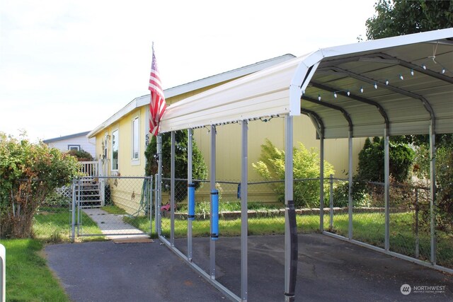 view of vehicle parking with a carport