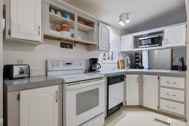 kitchen with dishwasher, sink, white electric range oven, white cabinetry, and stainless steel microwave