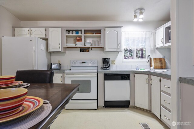 kitchen featuring white appliances, sink, and white cabinets