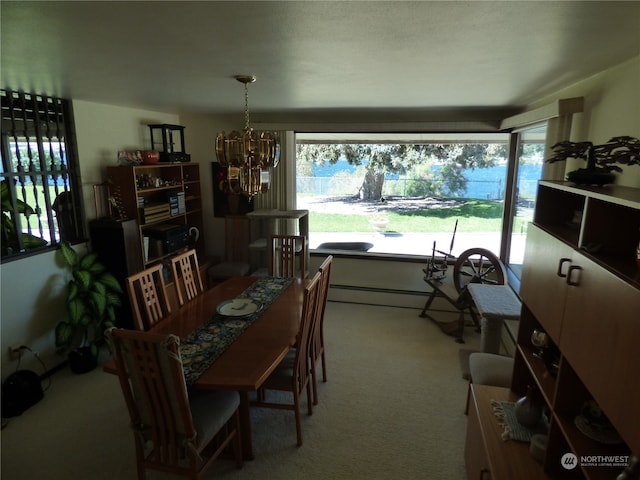 carpeted dining area featuring a baseboard radiator and a notable chandelier