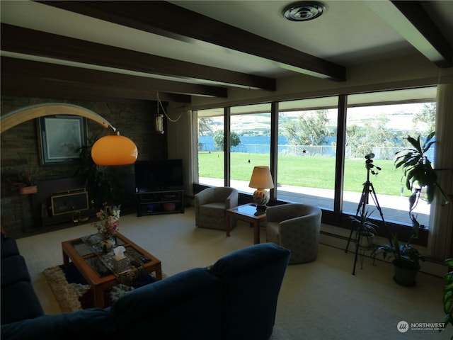 living room with a fireplace, beam ceiling, and carpet flooring