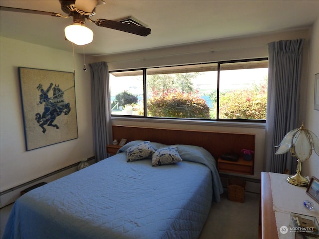 carpeted bedroom featuring ceiling fan and a baseboard radiator