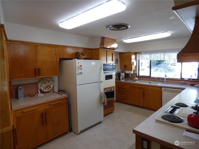 kitchen with custom range hood, sink, and white appliances