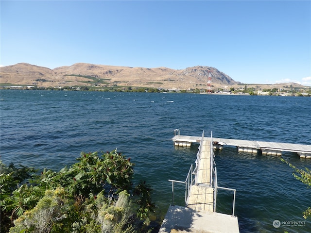 view of dock featuring a water and mountain view