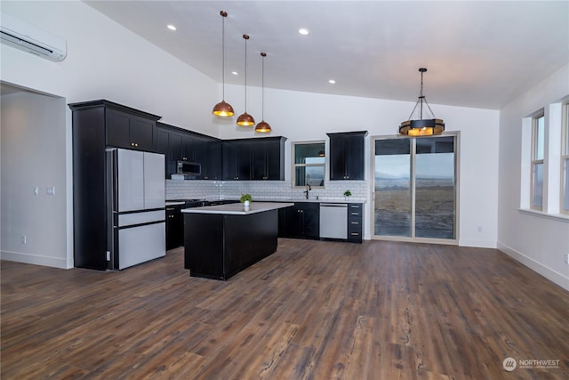 kitchen with pendant lighting, a center island, white fridge, and vaulted ceiling