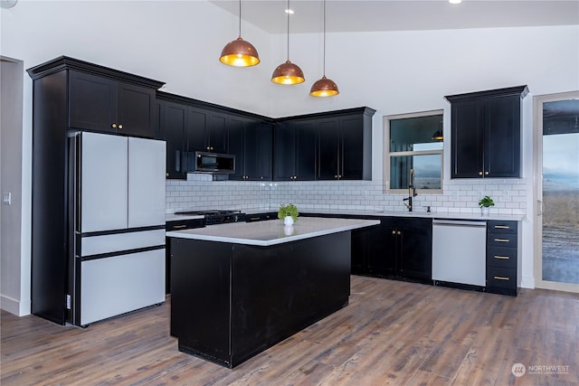 kitchen with dishwashing machine, dark hardwood / wood-style flooring, white fridge, and lofted ceiling