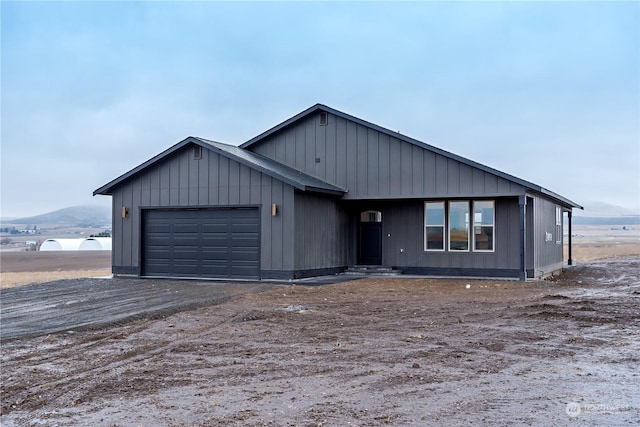 view of front of home with a mountain view and a garage