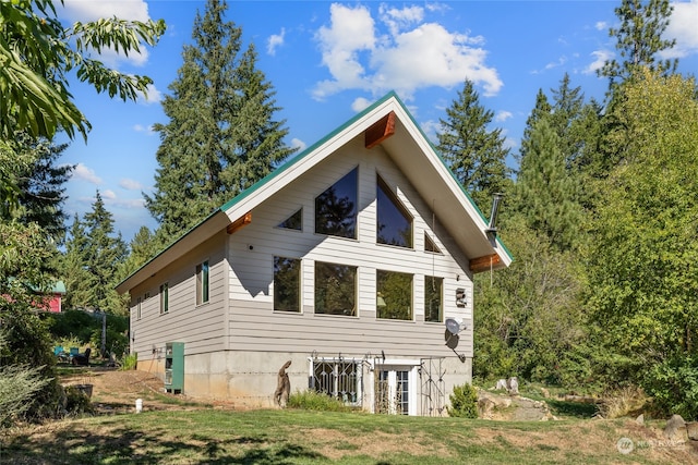 rear view of property featuring a yard