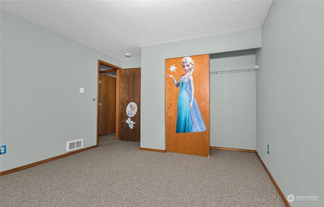 unfurnished bedroom with carpet flooring, a closet, visible vents, and baseboards