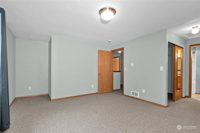 unfurnished bedroom with baseboards, visible vents, and carpet flooring