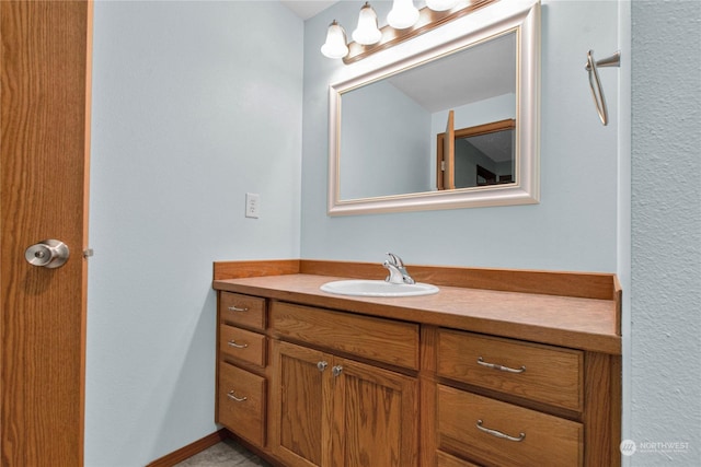 bathroom with baseboards and vanity