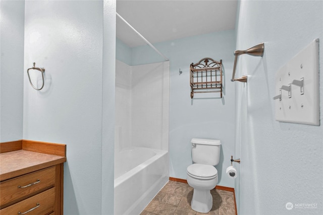 bathroom with washtub / shower combination, baseboards, vanity, and toilet