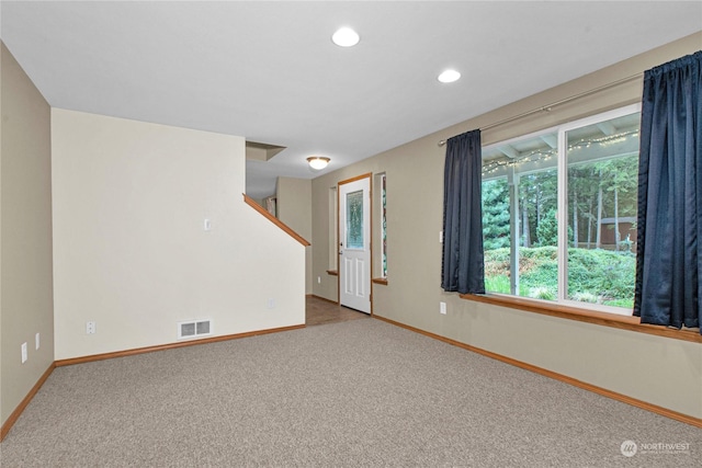 carpeted empty room with recessed lighting, visible vents, and baseboards