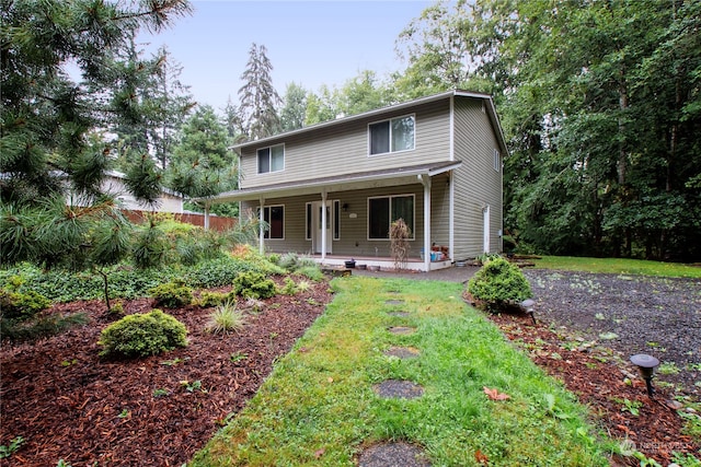 view of front of home with a porch and a front lawn