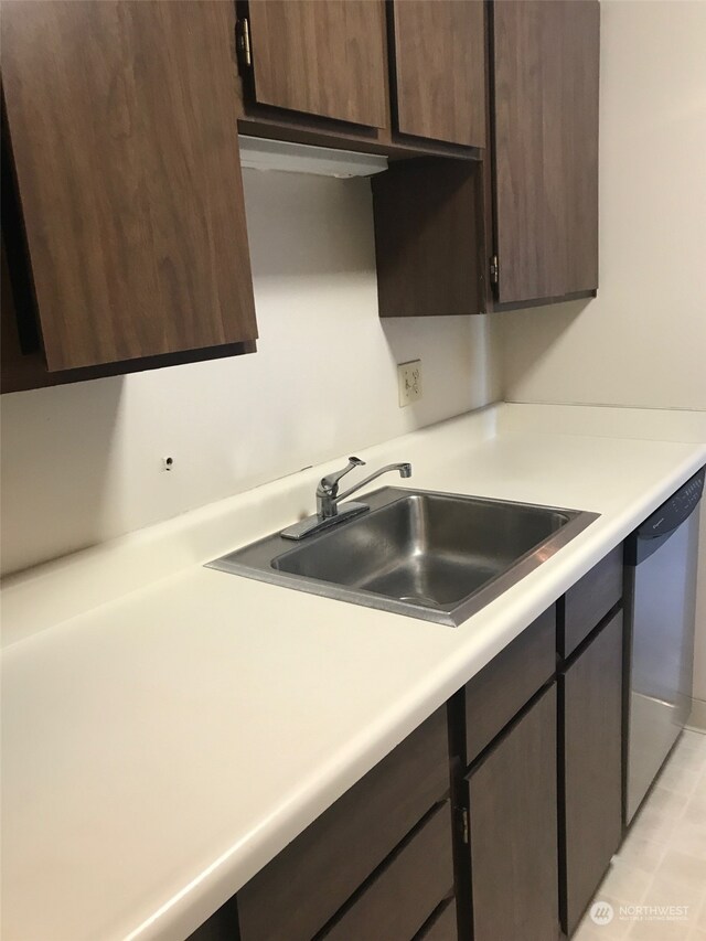 kitchen with dishwasher, dark brown cabinets, and sink