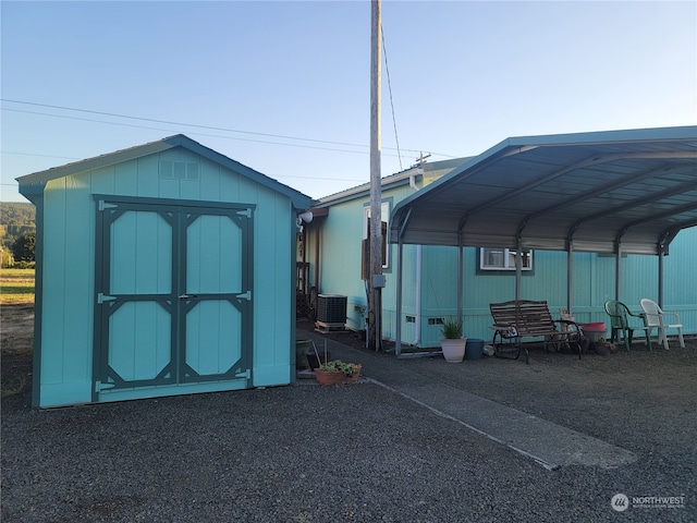 view of outbuilding featuring a carport and cooling unit