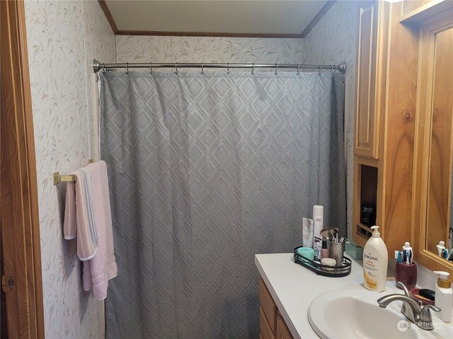 bathroom featuring crown molding, vanity, and a shower with shower curtain