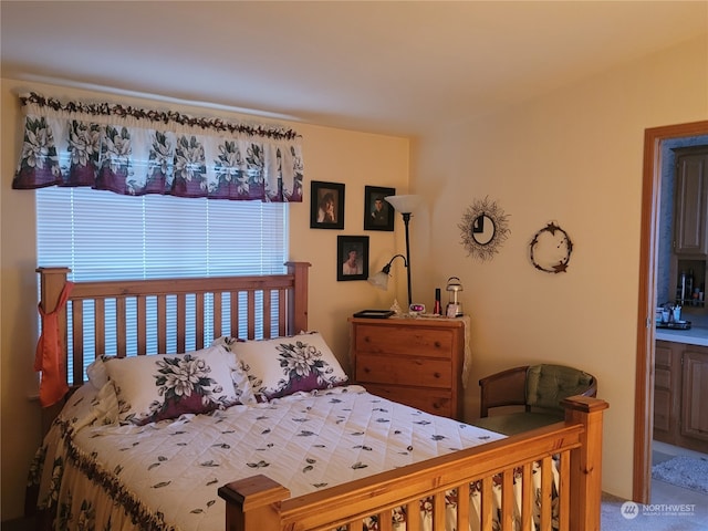 bedroom featuring carpet flooring and ensuite bath