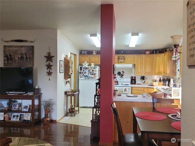 kitchen with white appliances, light brown cabinets, and light hardwood / wood-style floors