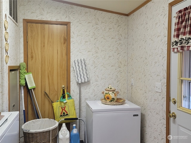 clothes washing area featuring ornamental molding and separate washer and dryer