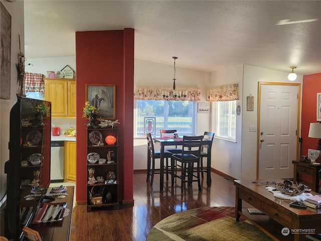 interior space with lofted ceiling, a chandelier, dark hardwood / wood-style flooring, and a textured ceiling