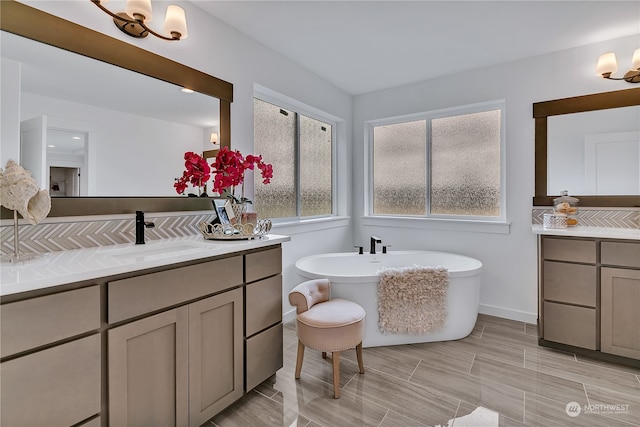 bathroom featuring a washtub and vanity