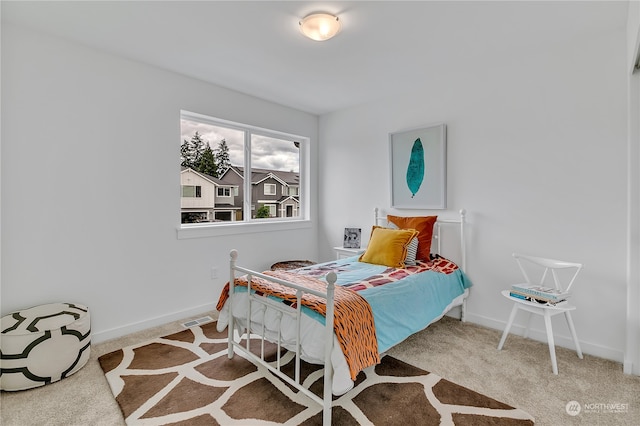 bedroom featuring light colored carpet