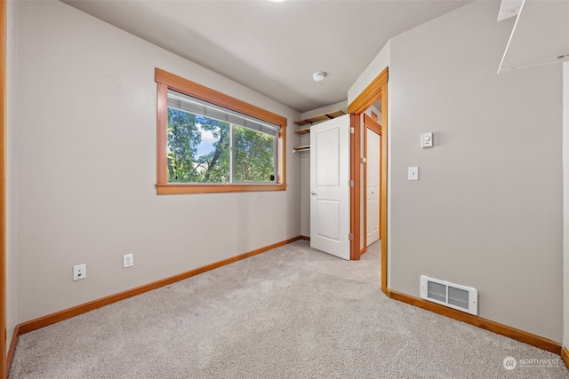 unfurnished room featuring light colored carpet