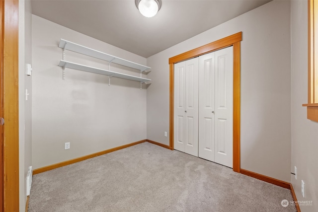 walk in closet featuring light colored carpet