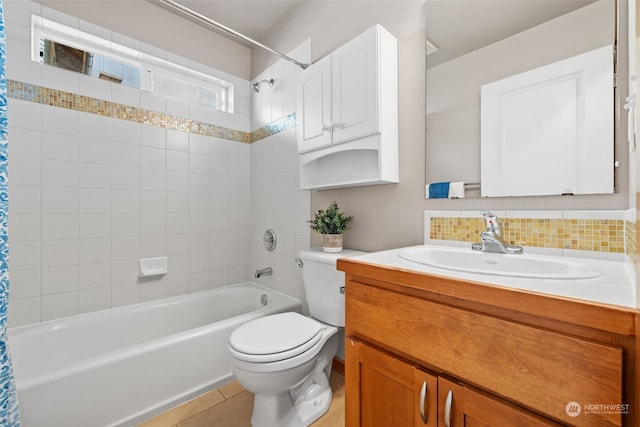 full bathroom featuring tile patterned floors, shower / bath combination with curtain, toilet, and vanity