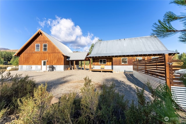 back of house featuring metal roof