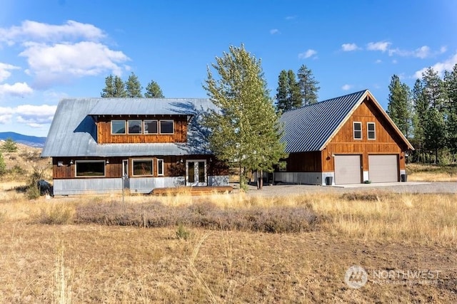 view of front of home with a garage and metal roof